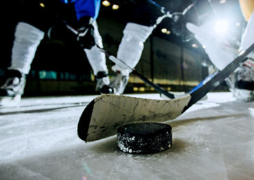 three hockey sticks fighting over a hockey puck