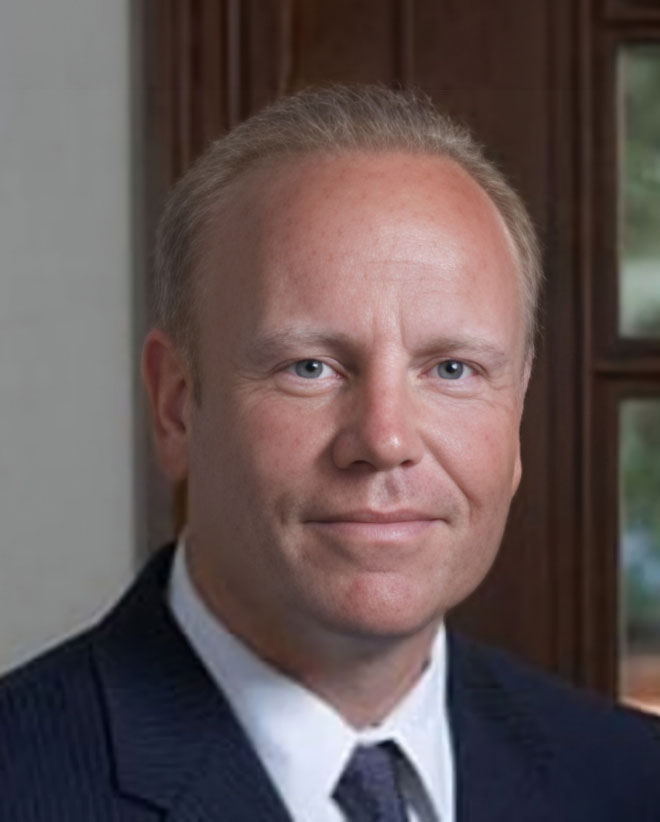 Headshot of Attorney Mark L. Floyd smiling in a blue suit